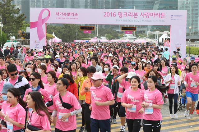 지난 4월 부산에서 열린 ‘핑크리본 사랑마라톤’ 대회에서 핑크색 옷을 입은 참가자들이 일제히 달리고 있다.  아모레퍼시픽 제공