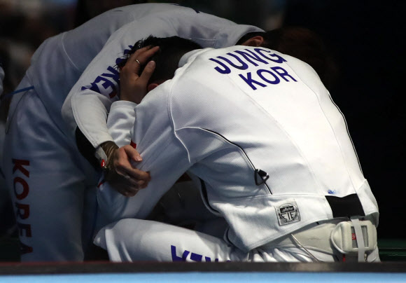 정진선이 14일(한국시간) 브라질 리우데자네이루의 바하 카리오카 경기장 3에서 열린 리우올림픽 펜싱 남자 에페 단체 헝가리와의 8강전에서 패배가 확정된 후 괴로워하자 동료가 위로하고 있다. 리우데자네이루 연합뉴스 