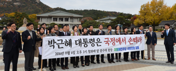 더불어민주당 설훈(오른쪽 아홉 번째) 의원 등 의원 22명이 6일 청와대 앞에서 ‘박근혜 대통령은 국정에서 손 떼라’고 적힌 플래카드를 들고 기자회견을 하고 있다. 손형준 기자 boltagoo@seoul.co.kr