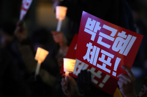국회에서 박근혜 대통령 탄핵안이 가결된 9일 오후 광주 동구 금남로에서 열린 시민 촛불집회에 참가한 시민이 촛불를 들고 있다. 연합뉴스