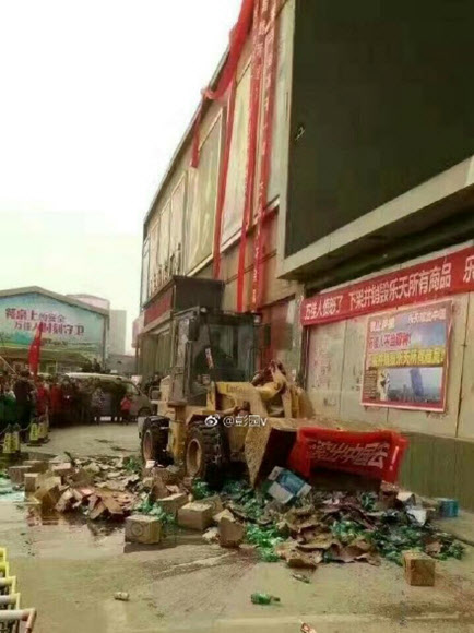 지난 5일 중국 시위대가 허난성 정저우 신정완자스다이광장에서 ‘처음처럼’ 등 롯데 제품을 중장비로 뭉개고 있다. 사진은 중국의 웨이보에 올라온 것을 캡처한 것. 연합뉴스