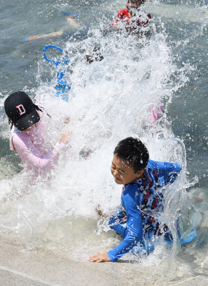 전국적으로 때이른 더위가 기승을 부린 21일 오후 서울 영등포구 여의도 물빛광장에서 어린이들이 물놀이를 하고 있다.  손형준 기자 boltagoo@seoul.co.kr