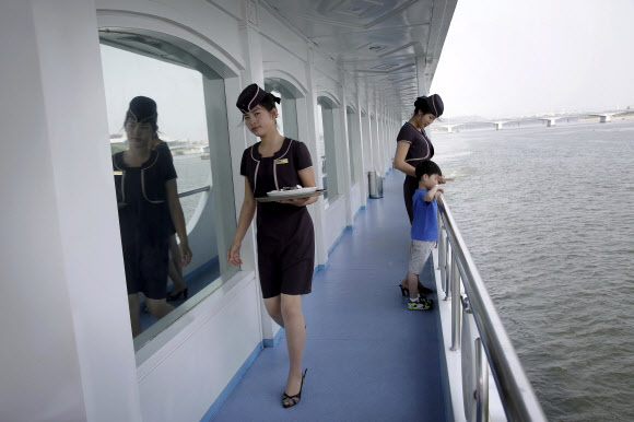 18일 북한 평양의 대동강 유람선 레스토랑 여직원들이 배안을 오가며 서비스를 하고 있다. AP 연합뉴스