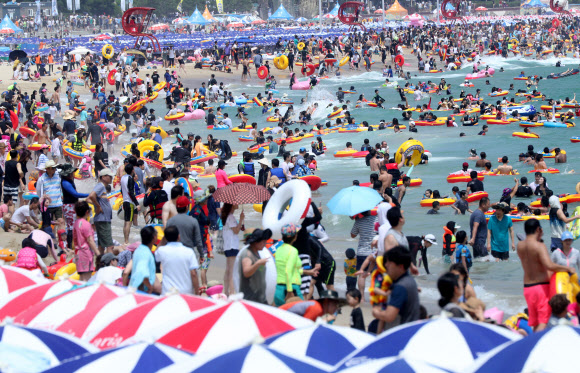 본격적인 휴가철을 맞은 30일 오후 부산 해운대구 해운대해수욕장에서 피서객들이 물놀이를 즐기고 있다.  연합뉴스