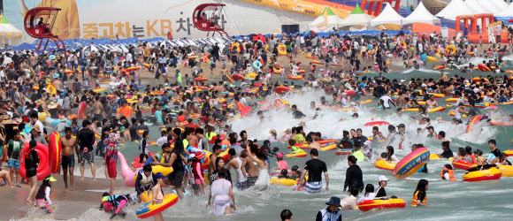 본격적인 휴가철을 맞은 30일 오후 부산 해운대구 해운대해수욕장에서 피서객들이 물놀이를 즐기고 있다.  연합뉴스