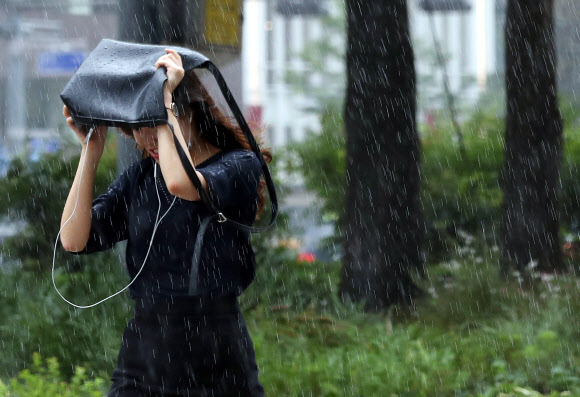 24일 오전 한 시민이 비 내리는 광화문네거리를 지나고 있다.  연합뉴스