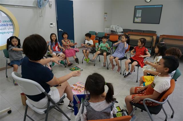 지난 24일 서울 강서구 화곡4동 강서영어도서관 영어 교육 프로그램에 참가한 아이들이 강사와 함께 손짓을 하며 영어로 이야기하고 있다.
