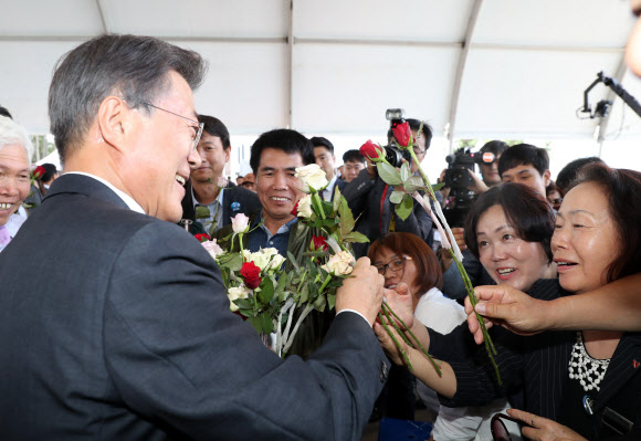 문재인 대통령이 15일 오후 충남 태안군 만리포해수욕장 일원에서 열린 ’함께 살린 바다 희망으로 돌아오다’ 서해안유류피해 극복 10주년 행사에서 기념사를 마치고 참석자들에게 장미꽃을 받고 있다.연합뉴스.