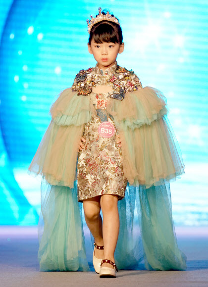 25일(현지시간) 중국 남서쪽 충칭에서 열린 ‘National kids model contest’ 결선에서 참가자들이 무대 위에서 런웨이를 하고 있다. 신화 연합뉴스
