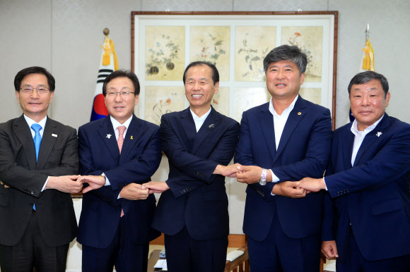 최명희(왼쪽부터) 강원도 시장군수협의회장, 민병희 강원도교육감, 최문순 강원도지사, 김동일 강원도의회 의장, 한의동 강원도 시군의회의장협의회장이 10일 강원도청에서 내년부터 무상급식을 고등학교까지 확대하기로 한 뒤 손을 맞잡고 포즈를 취하고 있다.<br>춘천 연합뉴스