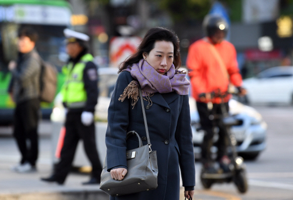 찬 공기와 강풍의 영향으로 기온이 크게 떨어진 30일 서울 종로구 광화문 네거리에서 출근하는 시민들이 걸음을 재촉하고 있다. 기상청은 이날 서울의 아침 최저기온이 영상 3도로 내려가고 강원 산간과 일부 내륙은 수은주가 영하로 떨어져 얼음이 어는 등 올 가을 들어 가장 추운 날씨를 보일 것이라고 예보했다. 2017. 10. 30. 박윤슬 기자 seul@seoul.co.kr