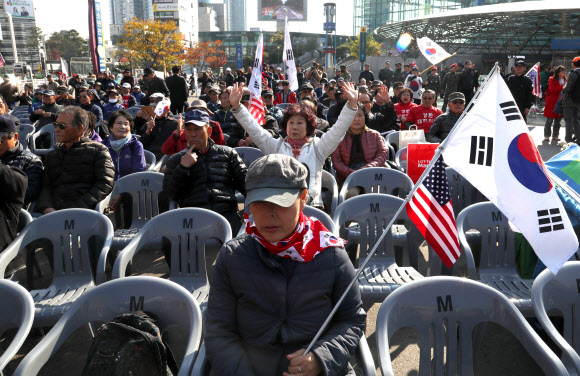 5일 오후 서울역 광장에서 열린 트럼프 미국 대통령의 방한 환영 집회에서 참가자들이 태극기와 성조기를 흔들고 있다.  연합뉴스