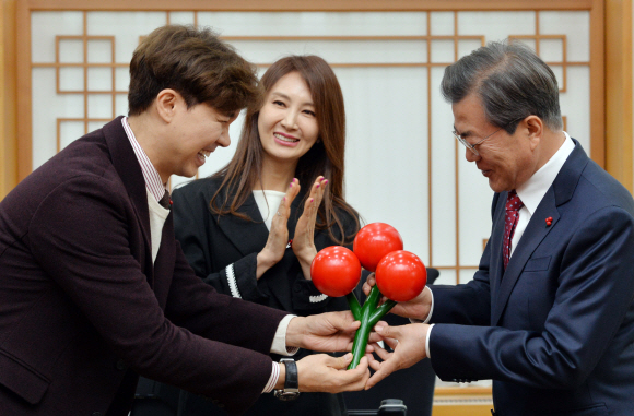 문재인 대통령이 20일 청와대 집무실에서 개그맨 박수홍씨로부터 사랑의 열매를 전달받고 있다. 가운데는 배우 채시라씨. 2017. 11. 20 안주영 기자 jya@seoul.co.kr