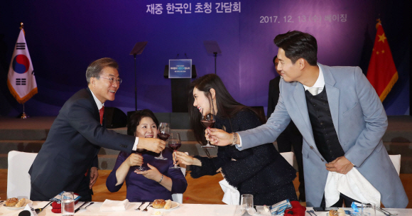 문재인 대통령과 부인 김정숙 여사가 13일 오후 중국 국빈방문 첫 일정으로 베이징에 위치한 완다 소피텔 호텔에서 열린 재중국 한국인 오찬 간담회에서 한인회장단, 독립유공자 후손, 한중 다문화 부부 등과 건배하고 있다. 오른쪽은 추자현-우효광 부부. 2017. 12. 13 안주영 기자 jya@seoul.co.kr