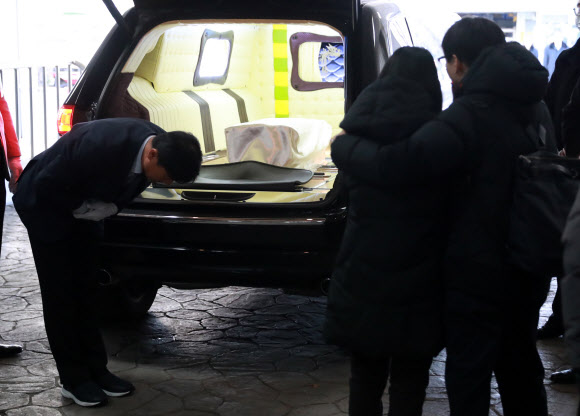 서울 양천구 이대목동병원에서 숨진 신생아의 장례 절차가 19일 진행됐다. 유가족이 운구차를 바라보고 있다.  연합뉴스