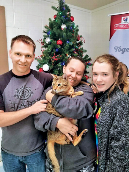 터틀 부부와 에밀리가 3년 만에 기적처럼 다시 찾은 고양이 라자를 껴안고 기뻐하고 있다. BVSPCA 제공
