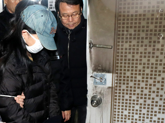 3일 오후 광주 북구 두암동 한 아파트에서 화재를 일으켜 세 남매를 숨지게 한 혐의로 구속된 20대 엄마 정모씨가 경찰과 현장검증을 하고 있다.  연합뉴스