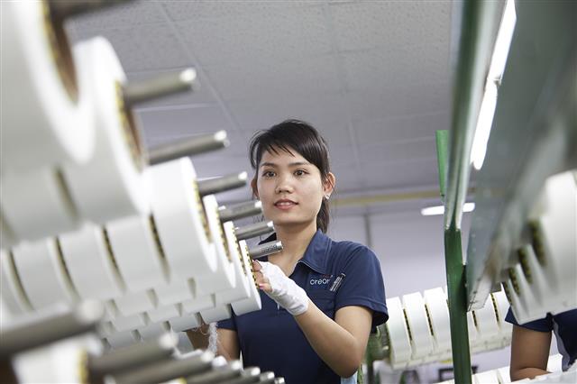 효성 베트남법인 스판덱스 공장에서 현지 직원이 스판덱스 제품의 품질을 확인하고 있다. 효성 제공