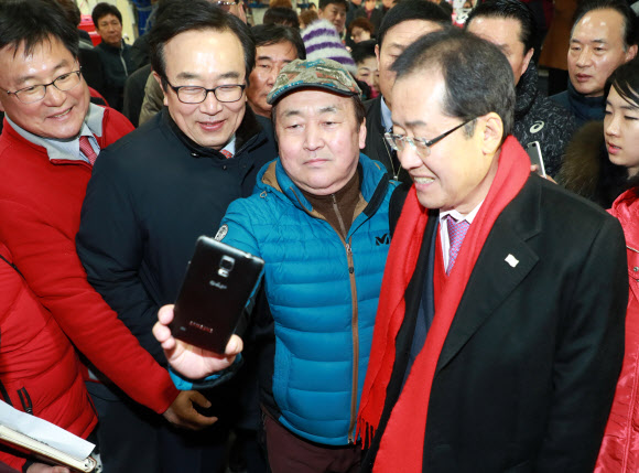 자유한국당 홍준표 대표와 서병수 부산시장이 12일 오후 부산 중구 자갈치 시장을 찾아 시민들과 기념사진을 찍고 있다.  연합뉴스