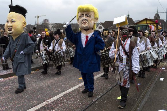 19일(현지시간) 스위스 바젤에서 열린 카니발에서 도널드 트럼프 미국 대통령과 김정은 북한 노동당 위원장(왼쪽)으로 분장한 참가자들이 행진하고 있다. EPA 연합뉴스
