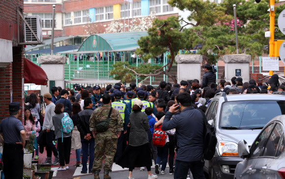 2일 오후 서울 서초구 방배초등학교에서 한 남성이 초등학생을 인질로 잡고 경찰과 대치하는 가운데 학교 앞이 시민들로 북적이고 있다.  연합뉴스