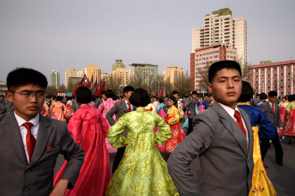 북한 김정일의 국방위원장 추대 25주년인 9일 평양 실내체육관 바깥에서 대규모 무도회에 참석한 대학생들이 춤을 추고 있다. 한 매체는 이날 밤 10시 현재까지 중앙보고대회가 열렸다는 보도를 하지 않고 있다. 김정은 체제 들어서도 행사가 생략된 적이 없었다. AFP 연합뉴스