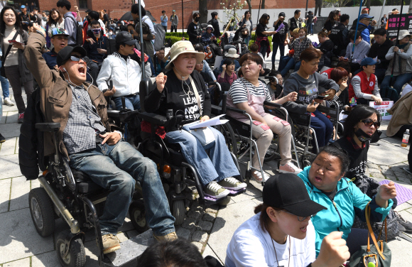 20일 서울 마로니에 공원에서 열린 420 장애인차별철폐 투쟁결의대회에 참석한 장애인들이 구호를 외치고 있다. 2018.4.20 박지환기자 popocar@seoul.co.kr