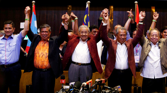 마하티르 모하맛(가운데) 전 총리와 그가 이끄는 신야권연합 희망연대(PH)의 주요 후보들이 10일 쿠알라룸푸르 부근의 페탈링자야에서 총선거 승리에 환호하고 있다.  말레이시아 로이터 연합뉴스