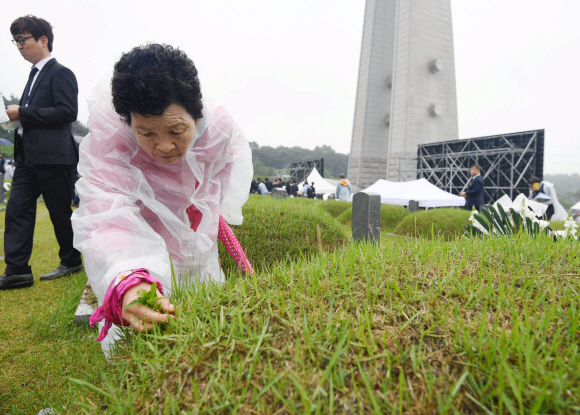 18일 광주 국립 5.18민주묘지에서 열린 ‘제38주년 5.18 민주화 운동 기념식’을 마친 뒤 유가족들이 고인의 묘를 살피고 있다. 2018. 05. 18 박윤슬 기자 seul@seoul.co.kr