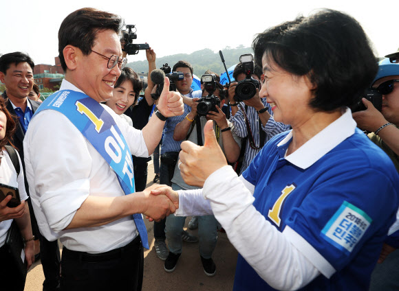 더불어민주당 이재명 경기도지사 후보(왼쪽)가 31일 오후 경기도 수원시 팔달구 화성행궁 광장에서 열린 경기도당 집중유세에서 추미애 대표와 악수를 하고 있다. 2018.5.31  연합뉴스