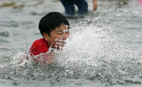 17일 서울 여의도 한강공원 물빛광장에서 어린이들이 시원하게 물놀이를 즐기고 있다. 2018.6.17 연합뉴스