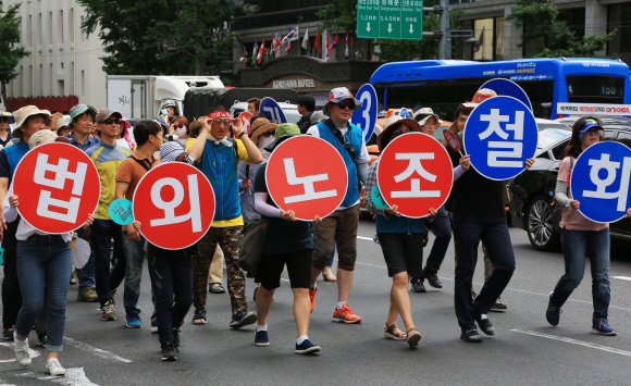 ‘법외노조 취소-노동3권 쟁취 전국교사결의대회’에 참가한 전국교직원노동조합(전교조) 조합원들이 6일 오후 서울 중구 서울파이낸스센터 앞에서 시위를하고 있다. 이날 참가자들은 법외노조 통보 취소, 해고자 복귀, 교사의 노동3권 보장, 성과급?교원평가 폐지를 촉구하며 연가투쟁을 벌였다. 2018.7.6이호정 기자hojeong@seoul.co.kr