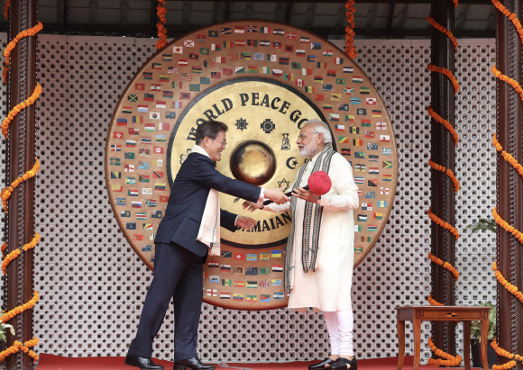 인도를 국빈 방문 중인 문재인 대통령이 9일(현지시간) 나렌드라 모디(오른쪽) 인도 총리와 함께 뉴델리 간디기념관을 방문해 세계 평화의 징을 치려 하고 있다. 뉴델리 도준석 기자 pado@seoul.co.kr