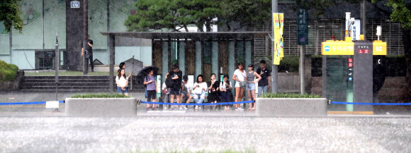 소나기 때문에 붐비는 버스정거장