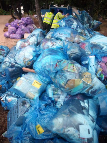 올여름 피서가 본격적으로 시작된 가운데 30일 새벽 강원 강릉시 경포 해수욕장에서 환경미화원이 수거해 온 쓰레기를 정리하고 있다. 2018.7.30  연합뉴스