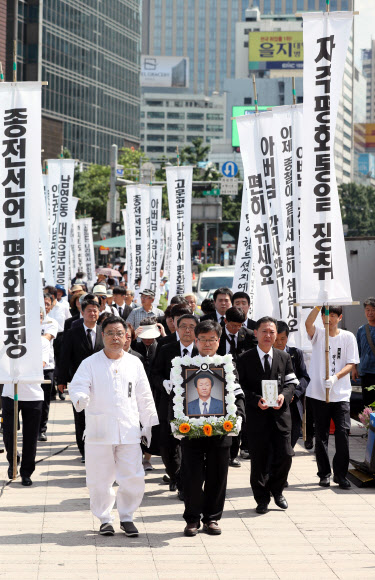 1987년 경찰의 고문으로 숨진 6월 항쟁 도화선 고 박종철 열사의 아버지 박정기 씨의 노제가 열린 31일 오후 유가족이 고인의 영정을 들고 서울광장으로 들어서고 있다. 2018.7.31  연합뉴스