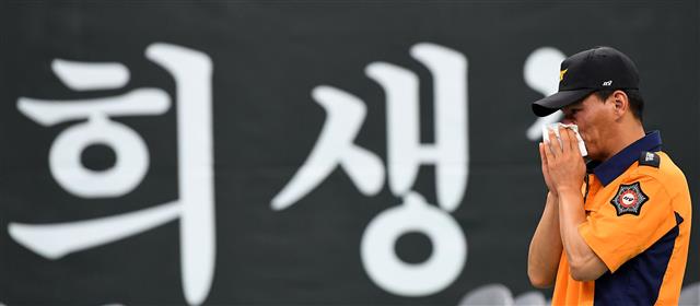 한강 하류에서 구조 출동 중 보트 전복으로 순직한 오동진(37) 소방위와 심문규(37) 소방장의 합동 영결식이 거행된 16일 김포생활체육관에서 영결식이 끝난 후 남은 동료 소방관이 슬픔에 잠겨있다. 2018.8.16 뉴스1