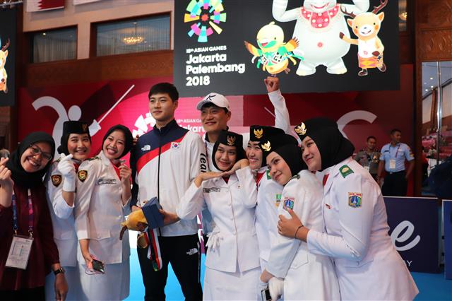 펜싱의 오상욱이 지난 20일 인도네시아 자카르타 컨벤션센터(JCC)에서 열린 2018 자카르타·팔렘방아시안게임 남자 사브르 개인전에서 은메달을 획득한 뒤 현지 팬들과 즐거운 표정으로 사진을 찍고 있다.