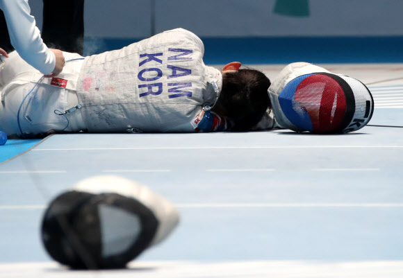 23일 오후(현지시간) 자카르타 컨벤션센터에서 열린 2018 자카르타?팔렘방 아시안게임 펜싱 여자 플뢰레 준결승 한국 대 일본 경기에서 8번째 경기에 나선 ‘맏언니’ 남현희가 맹추격을 하던 중 부상을 당해 치료를 받으며 고통스러워 하고 있다.  2018.8.23  연합뉴스