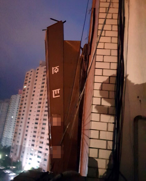 제19호 태풍 ‘솔릭’의 강풍 탓에 24일 오전 부산 사하구 다대동의 한 건물 6층 옥상의 교회 첨탑이 부러져 건물 외벽에 걸려있다. 2018.8.24  부산경찰청 제공