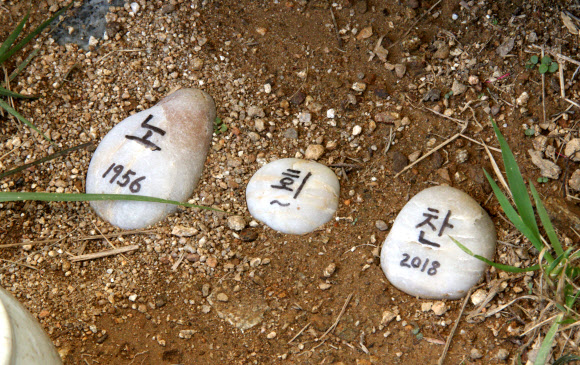 ‘하얀 돌멩이 위에 적힌 노회찬’