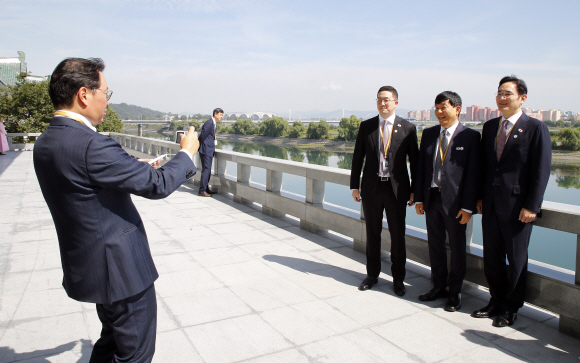 19일 낮 평양 옥류관에서 열린 남북 정상 및 수행원 오찬에 앞서 최태원 SK 회장이 이재용 삼성전자 부회장(오른쪽부터), 이재웅 쏘카 대표, LG 구광모 회장의 기념사진을 찍어주고 있다. 2018.9.19/평양사진공동취재단