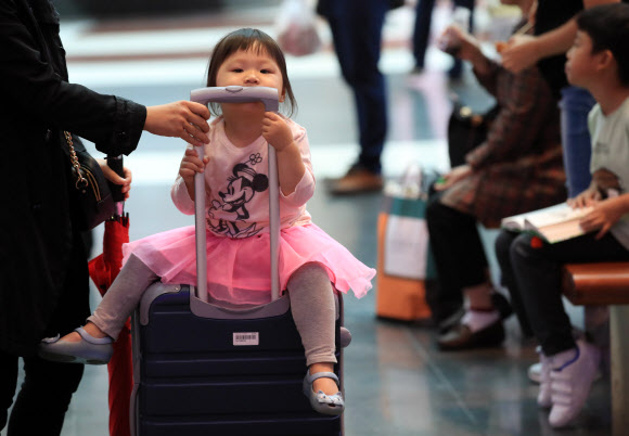 21일 오전 서울 용산역에서 어린이가 추석 명절 연휴를 맞아 여행용 캐리어 가방을 타고 고향으로 향하고 있다. 2018.9.21  연합뉴스
