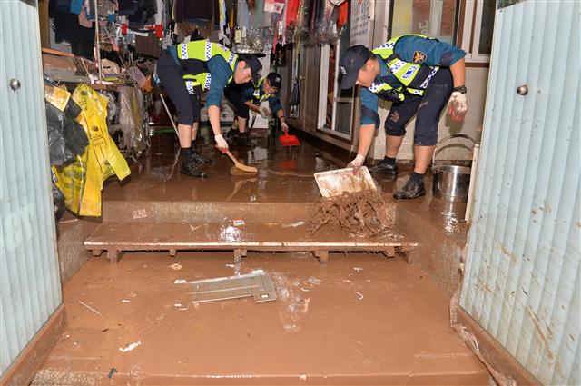 경북경찰청 경찰병력이 7일 태풍 콩레이가 쏟아부은 물폭탄에 침수 피해를 당한 경북 영덕군 강구면 강구전통시장에서 복구 작업을 하고 있다. 2018.10.7 뉴스1
