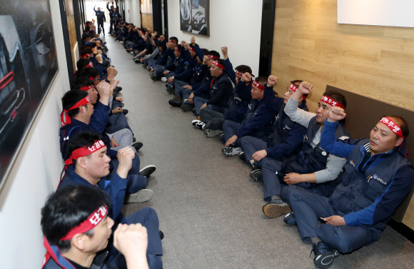 한국지엠(GM) 주주총회가 열리는 19일 오후 주주총회 장소로 알려진 인천시 부평구 한국지엠 부평공장 본사 사장실 주 통로 앞에서 전국금속노동조합 한국GM지부 노조원들이 구호를 외치고 있다. 한국GM은 이날 주주총회를 소집해 글로벌 제품 연구개발을 전담할 신설 법인 설립 안건을 통과시킬 예정이, 한국지엠 노조원들은 이를 저지할 계획이다. 2018.10.19  연합뉴스