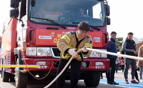 25일 서울 여의도공원에서 서울시 2018년 ‘서울안전한마당’ 행사의 일환으로 열린 소방차끌기대회에 참가한 소방대원이 혼신을 다해 경기에 임하고 있다. 2018.10.25 이종원 선임기자 jongwon@seoul.co.kr