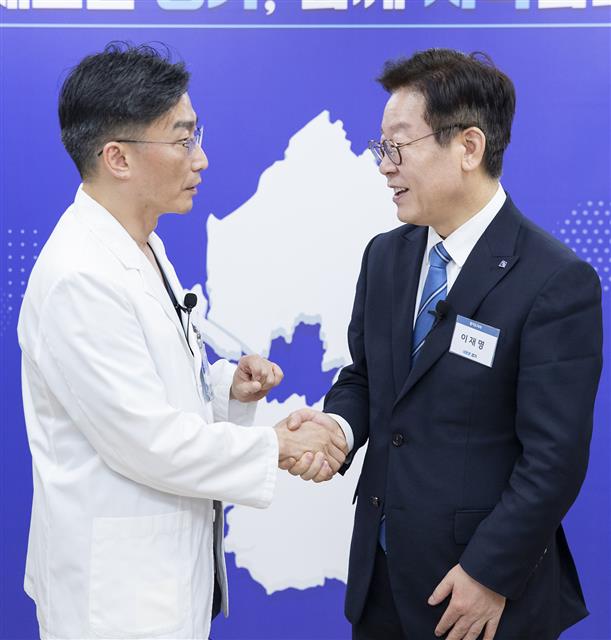 이재명 경기도지사와 이국종 경기남부권역 외상센터 센터장이 27일 오후 경기도청 도지사 집무실에서 열린 ‘경기도 중증외상환자 이송체계 구축 업무협약’ 체결 후 악수를 하고 있다.  경기도 제공
