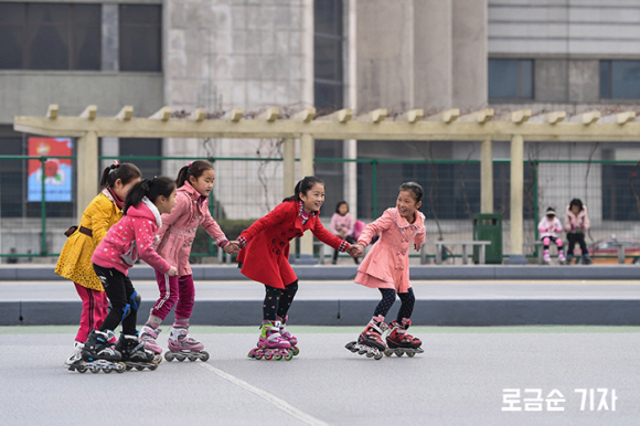 평양의 한 ‘로라 스케트장’에서 손에 손잡고 스케이팅을 즐기는 북한 어린이들. 민플러스 제공