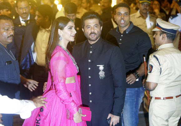 Bollywood actor Anil Kapoor and his daughter Sonam Kapoor arrive to attend the wedding of Isha Ambani, the daughter of Reliance Industries Chairman Mukesh Ambani, and Anand Piramal in Mumbai, India, Wednesday, Dec. 12, 2018. In a season of big Indian weddings, the Wednesday marriage of the scions of two billionaire families might be the biggest of them all. Isha is the Ivy League-educated daughter of industrialist Mukesh Ambani, thought to be India‘s richest man. The groom is the son of industrialist Ajay Piramal, thought to be worth  billion. AP 연합뉴스