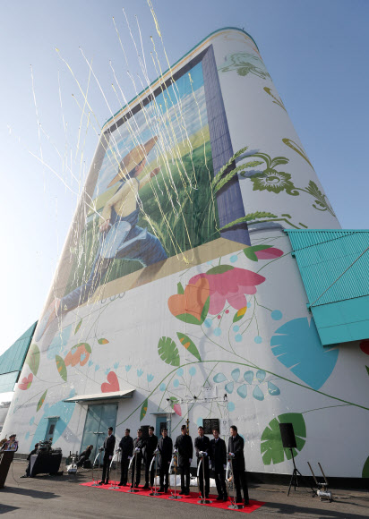 17일 오전 인천시 중구 인천항 7부두 내 사일로(Silo·곡식저장시설)에서 열린 ‘인천항 사일로 벽화 기네스북 등재 기념식’에서 허종식 인천시 균형발전 정무부시장과 남봉현 인천항만공사 사장 등 주요 내빈들이 사일로 벽화 기네스북 등재를 알리는 축포를 터트리고 있다. 이 벽화는 높이 48m, 길이 168m, 폭 31.5m 규모로 시간의 흐름을 상징하는 봄·여름·가을·겨울 북 커버 장식이 그려졌고 성장 과정을 의미하는 문구가 16권의 책 제목으로 디자인됐다. 이 벽화는 ‘세계에서 가장 큰 야외벽화’로 기네스북에 이름을 올렸다. 2018.12.17  연합뉴스